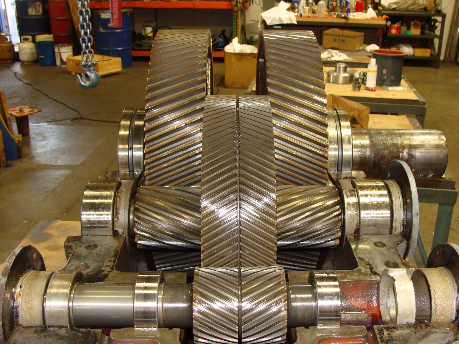 Set of double helical gear shafts removed from an industrial gearbox