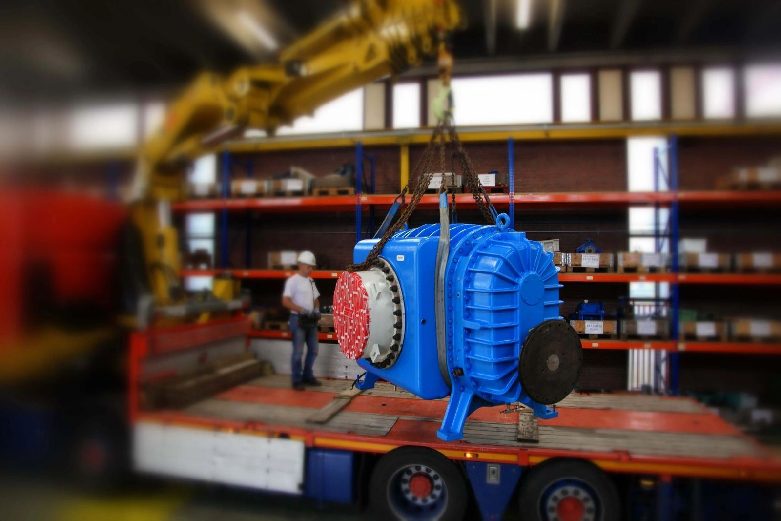 Rebuilt blower lifted by crane onto a truck for shipment