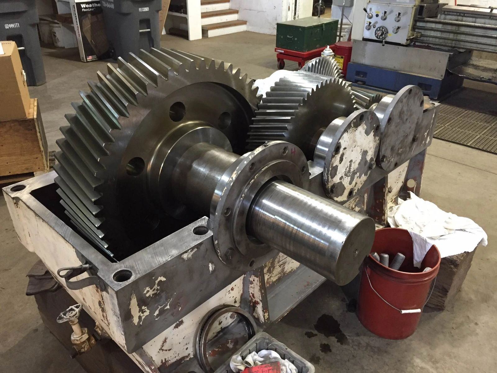 Large helical gear and shaft being fitted during gearbox assembly