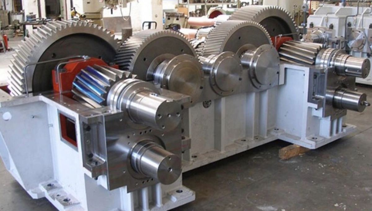 Industrial gearbox opened to expose its gear train during rebuild