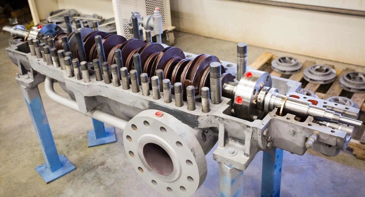 Multistage pump rotor and shaft assembly laid out on a work stand