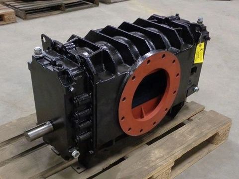 Rebuilt black positive displacement blower on a pallet with red flange covers