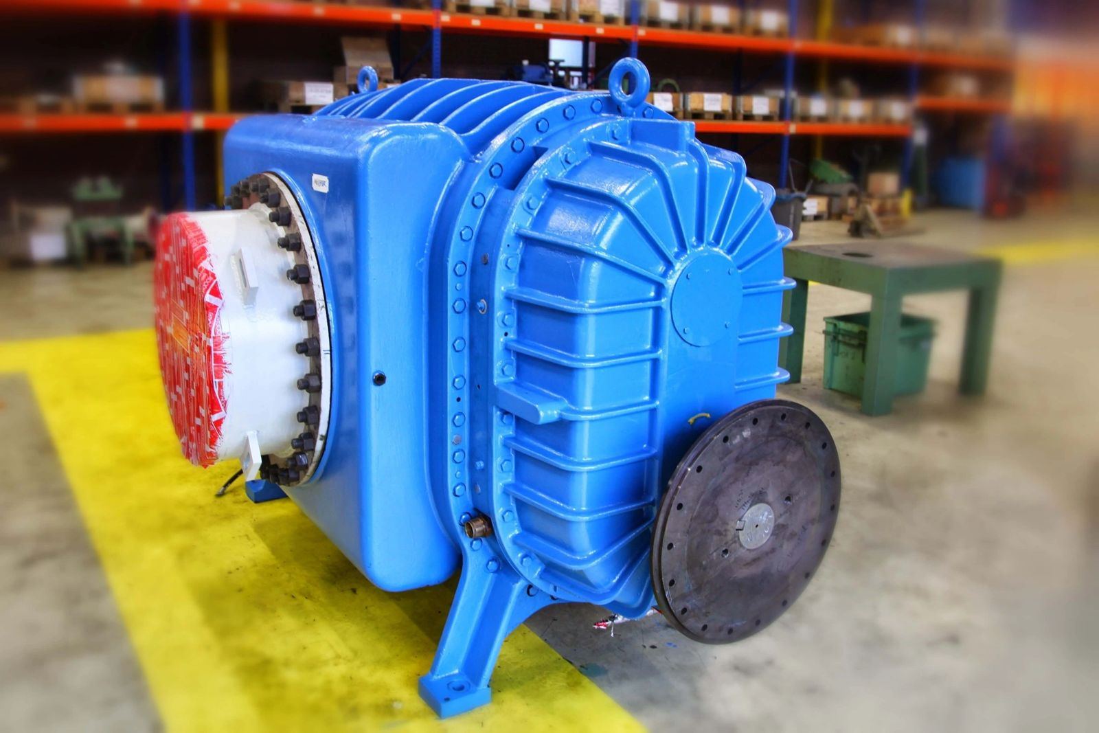 Rebuilt blue positive displacement blower with exposed rotor lobes on the shop floor
