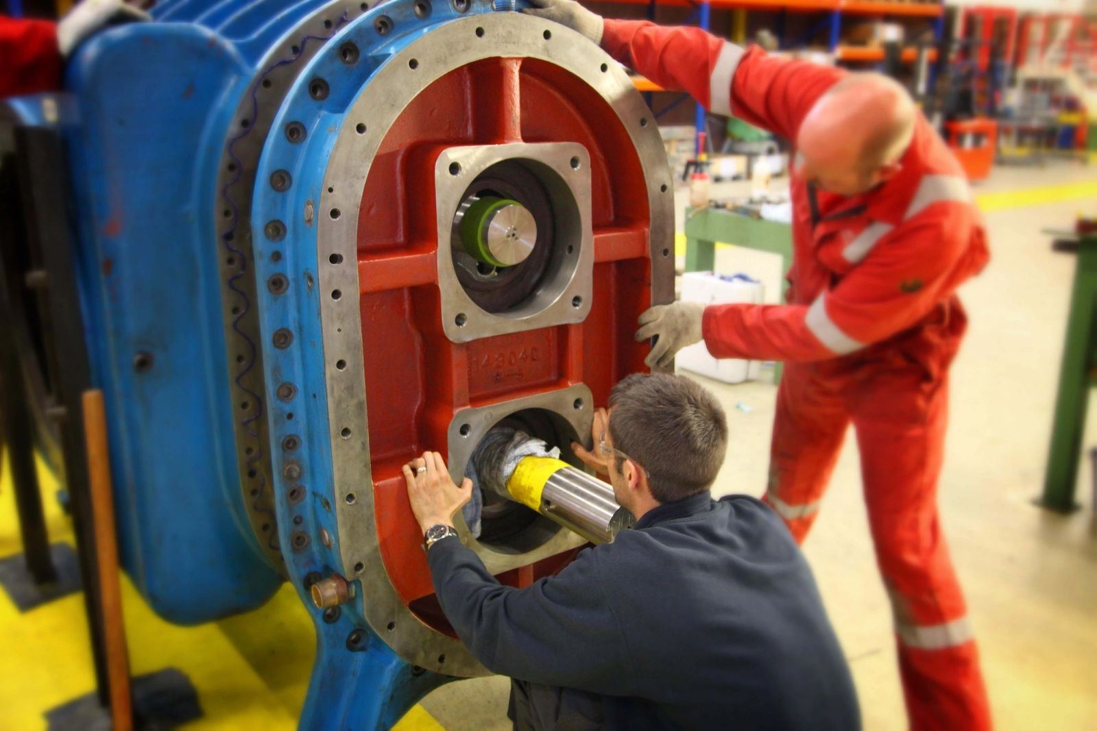 IES technicians inspecting an opened gearbox housing during teardown