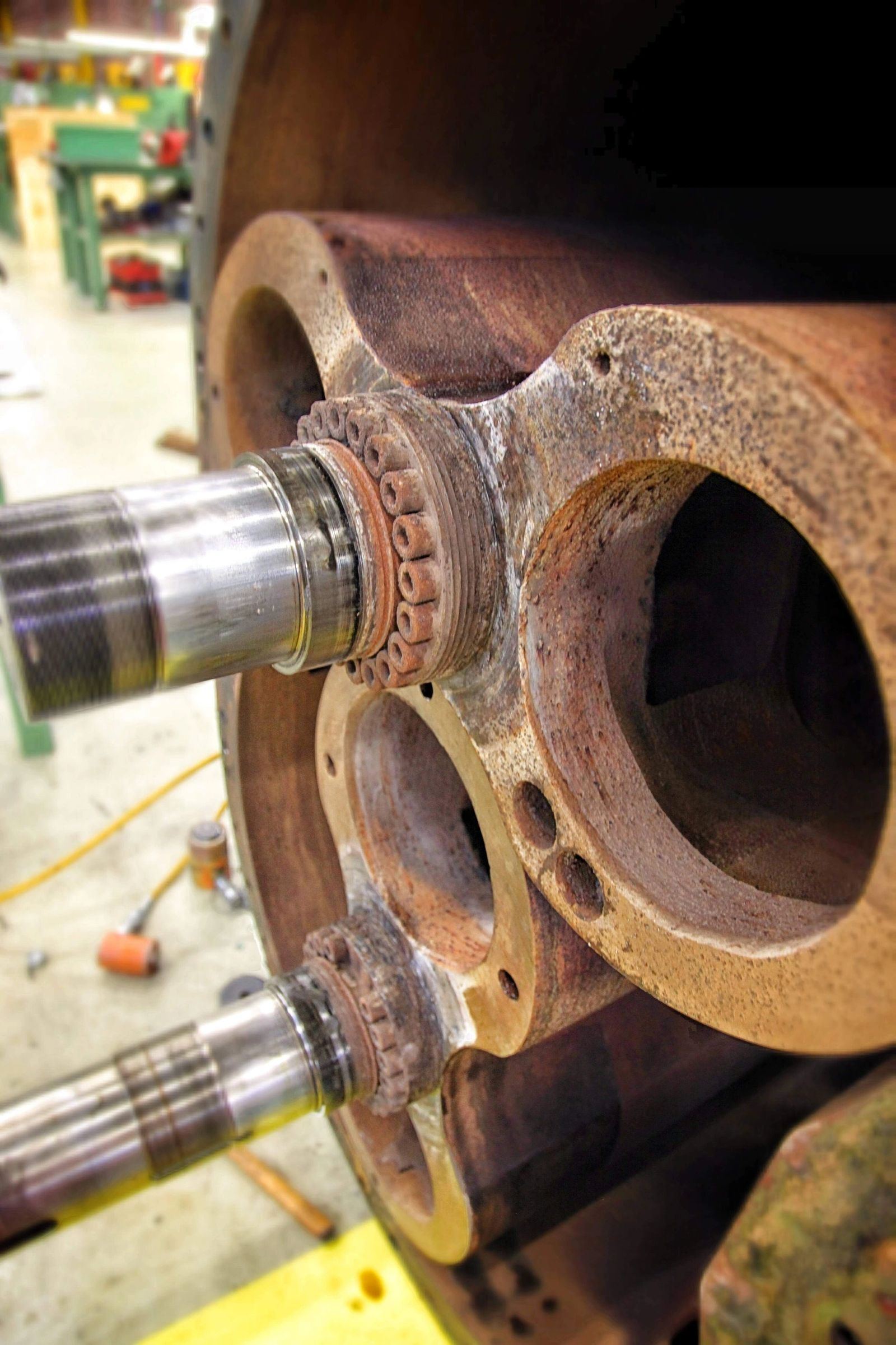 Worn gearbox housing bore and shaft inspected for wear before rebuild